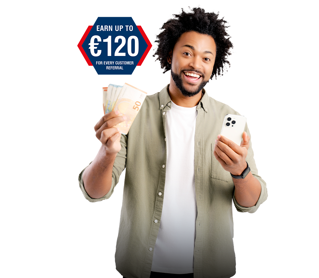 man smiling holding money in one hand and a mobile phone in the other hand
